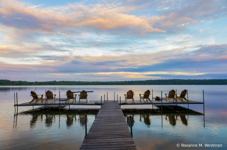 Sitting on a dock at sunset