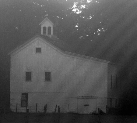 Foggy barn showing rainbow/halo