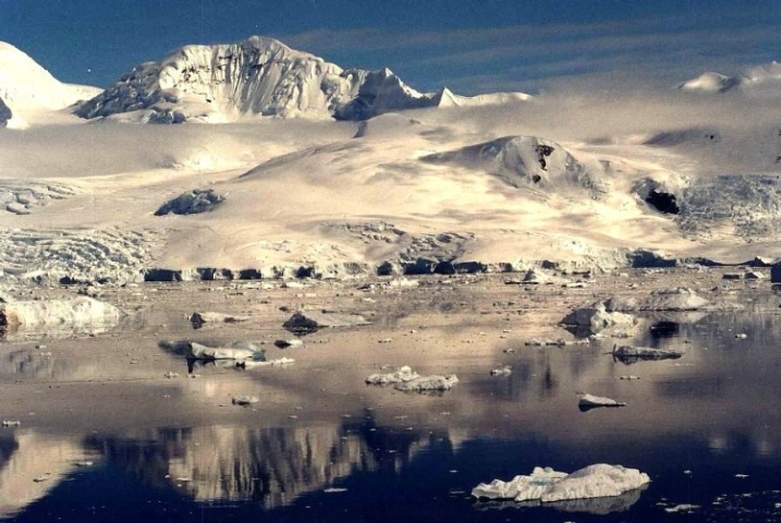 Fog lifting over snowy mountain