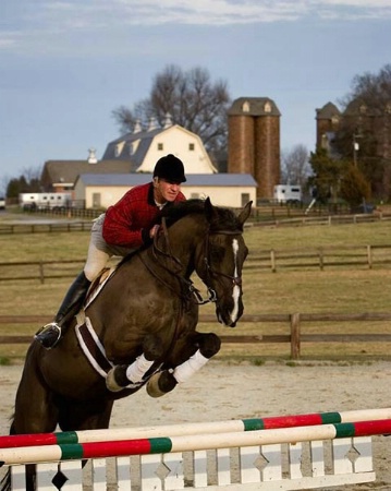 Trainer in perfect form on a horse farm