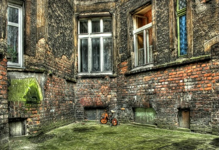 a corner with orange child bicycle