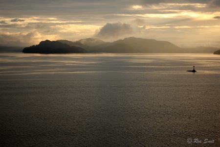 Clouds, Islands and Water coloured by the sunset.