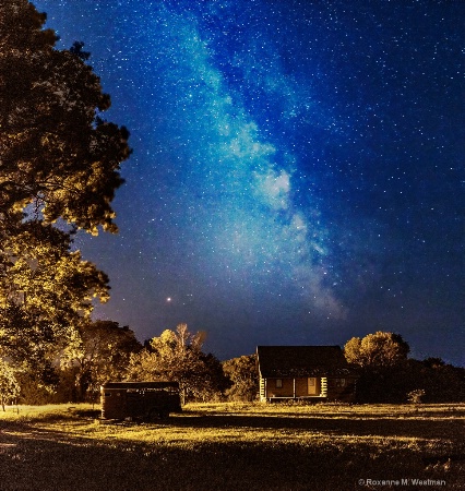 Milky way and cabin in the woods